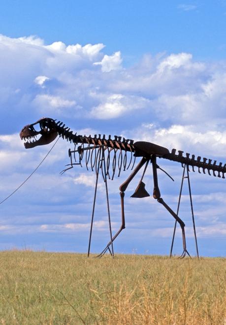 Dinosaur and man sculpture