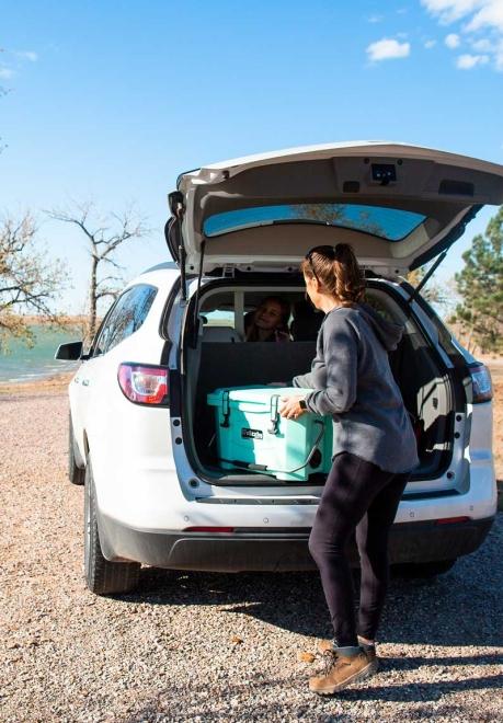 Woman removing cooler from car at Rocky Point Recreation Area