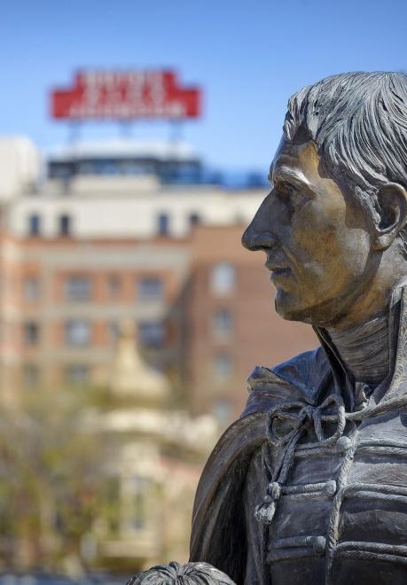 A presidential statue stands in profile against the Hotel Alex Johnson in Rapid City, South Dakota.