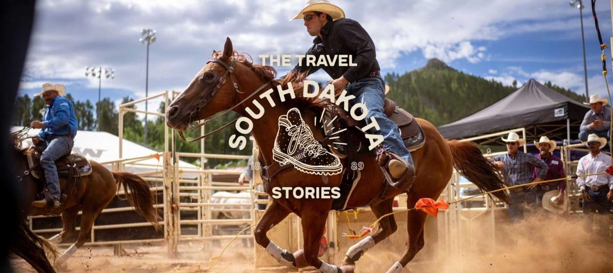 a cowboy rides on horseback at a rodeo in South Dakota.