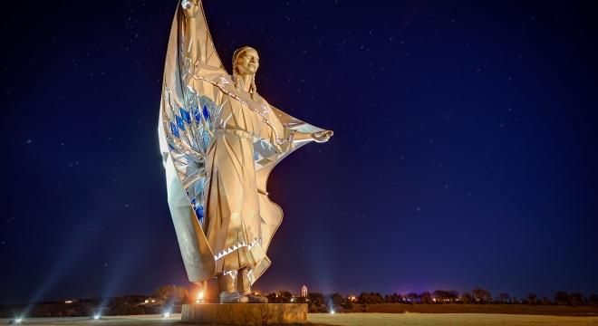 Dignity sculpture at night