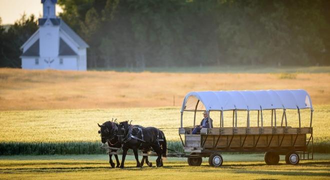 Covered wagon with horse and church (long crop)